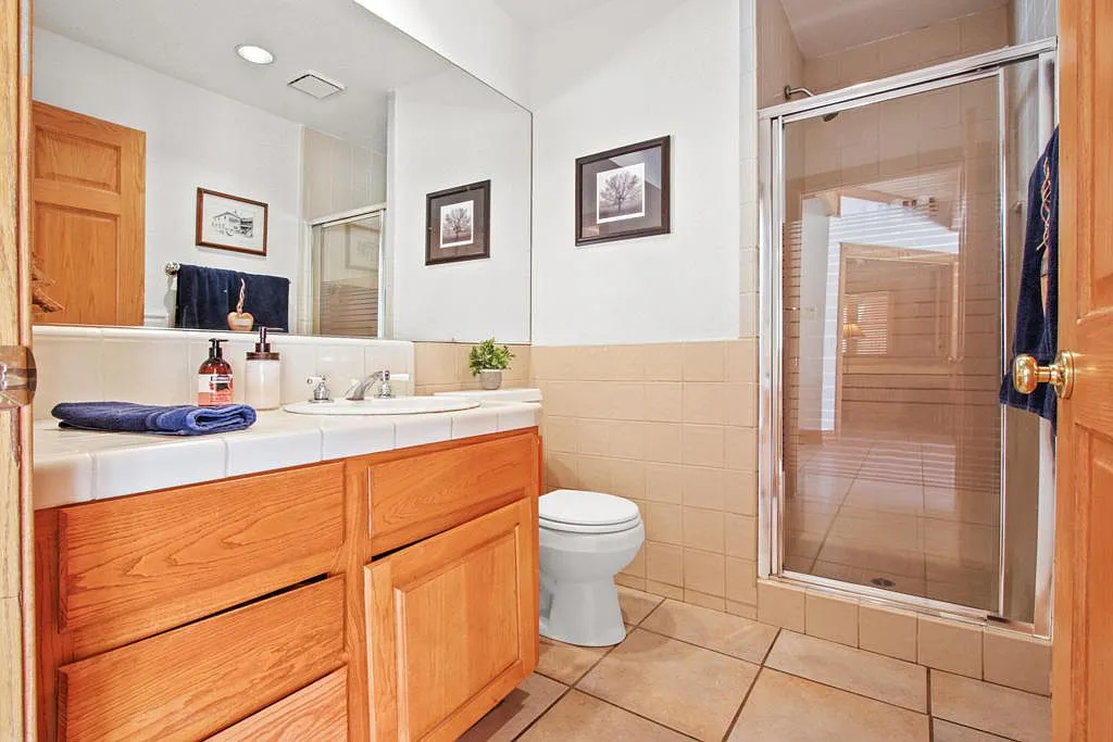 Bathroom with an oak vanity and glass shower stall
