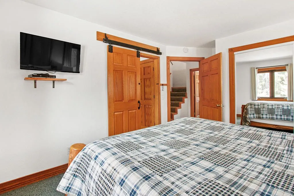 Bedroom with a sliding barn door and wall mounted television