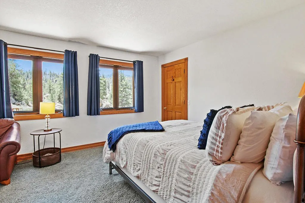 Bedroom with windows looking straight into the pines