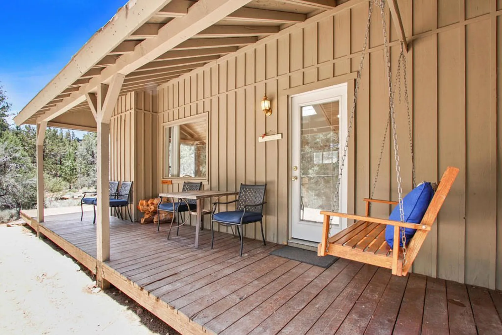 Ironwood cabin porch with a hanging swing and patio seating