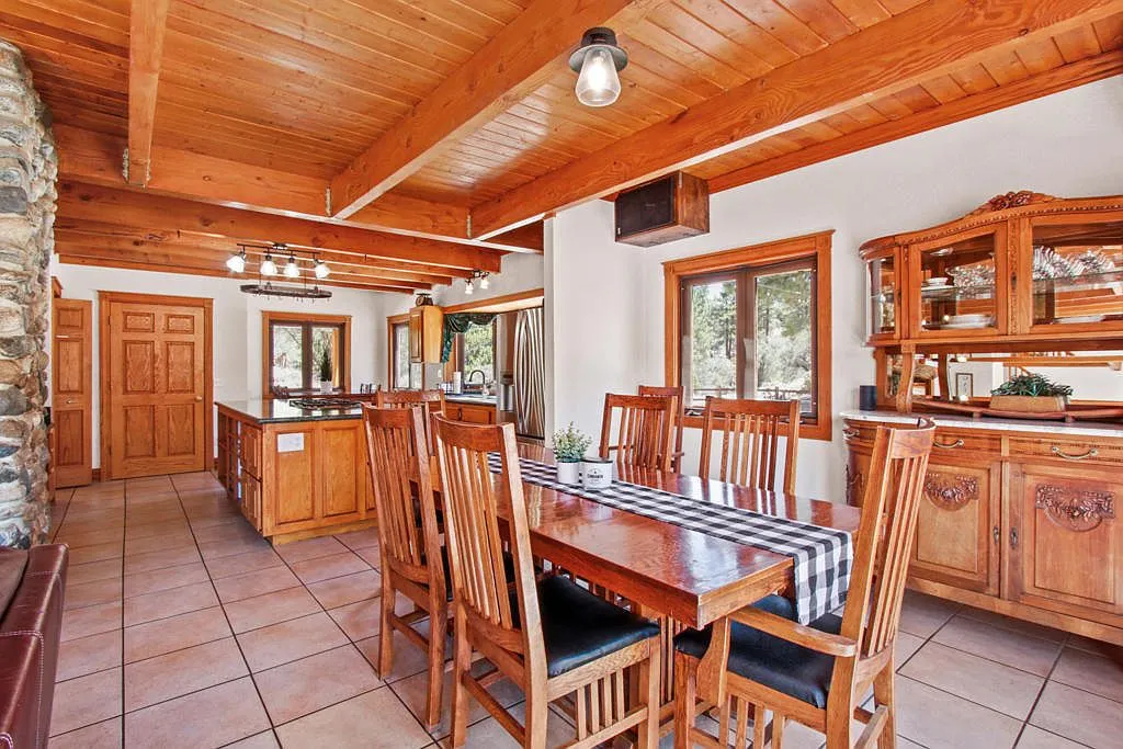 Dining room with an antique hutch looking through to the kitchen island