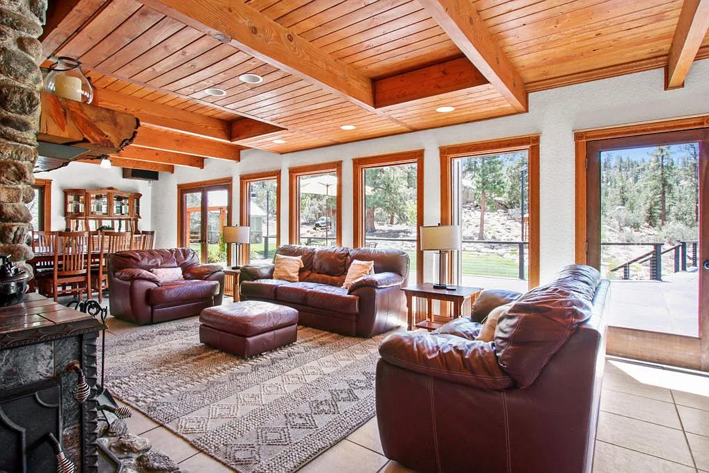 Lodge great room with a wall of windows and doors onto the deck