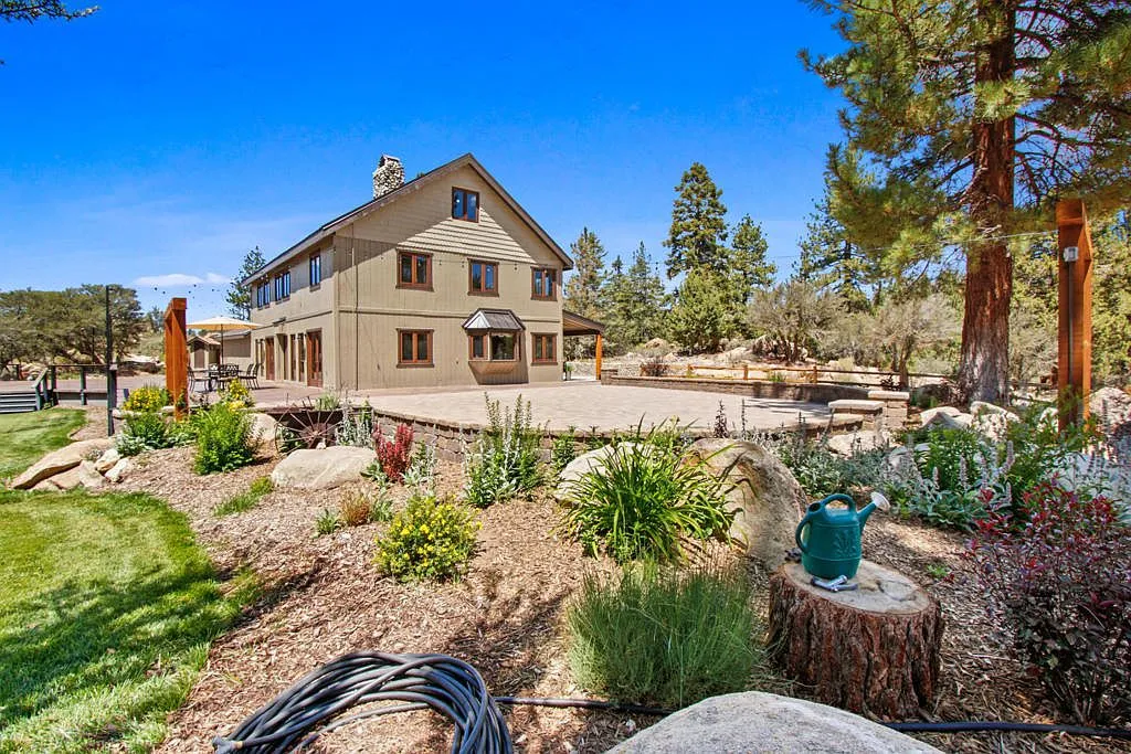Landscaped boulder garden beds in flower with the Lodge behind